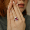 Oval Cut Ruby Solitaire with Tapered Diamond Halo