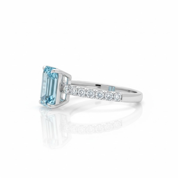 Emerald-Cut Blue Topaz Solitaire Ring in 14K White Gold with Pavé Diamond Band